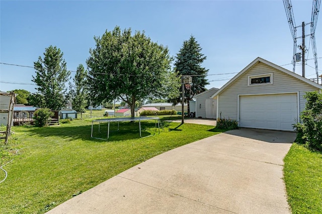 view of yard featuring a garage and an outdoor structure