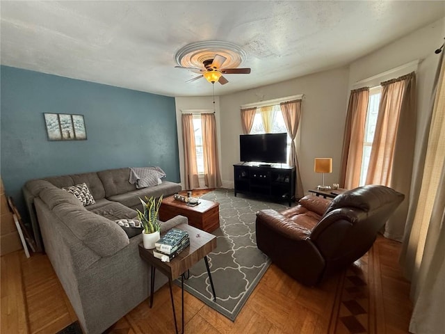 living room with parquet floors and ceiling fan