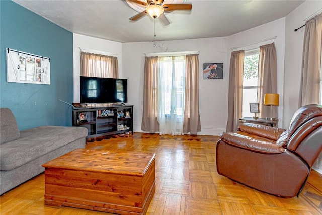 living room with ceiling fan and light parquet flooring