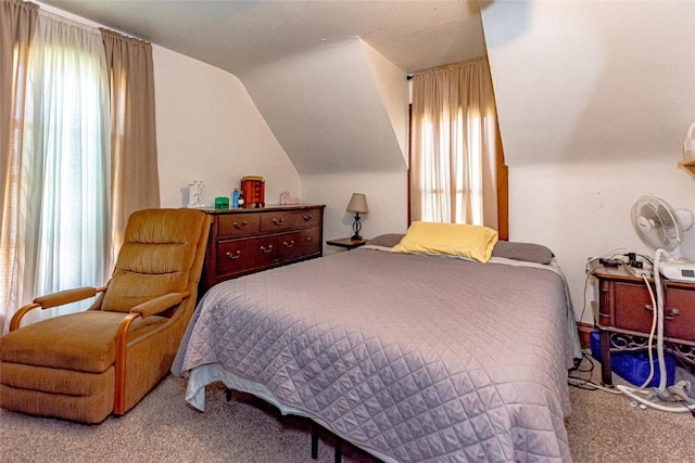 carpeted bedroom featuring lofted ceiling