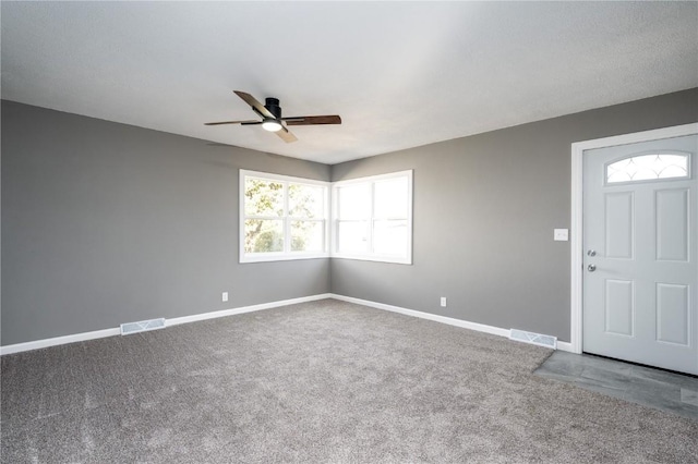 entrance foyer featuring carpet floors and ceiling fan