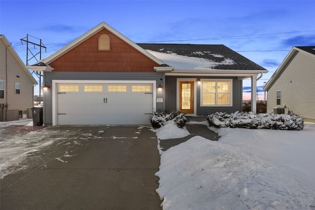 view of front of house with a garage and central AC unit