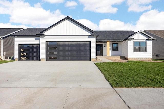 view of front of house with a garage and a front yard