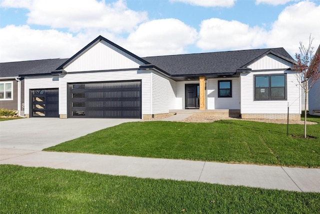 view of front of property with a garage and a front lawn