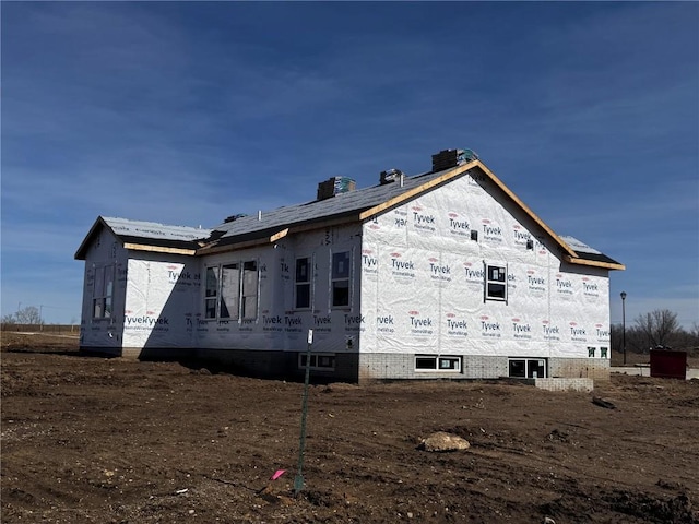 view of side of home featuring a chimney