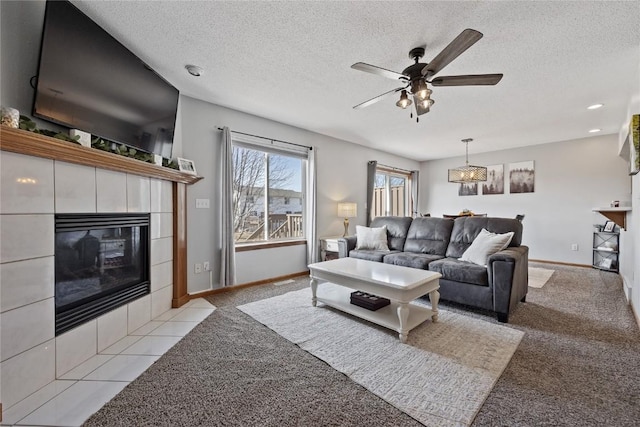 living room featuring light carpet, a tile fireplace, and a textured ceiling