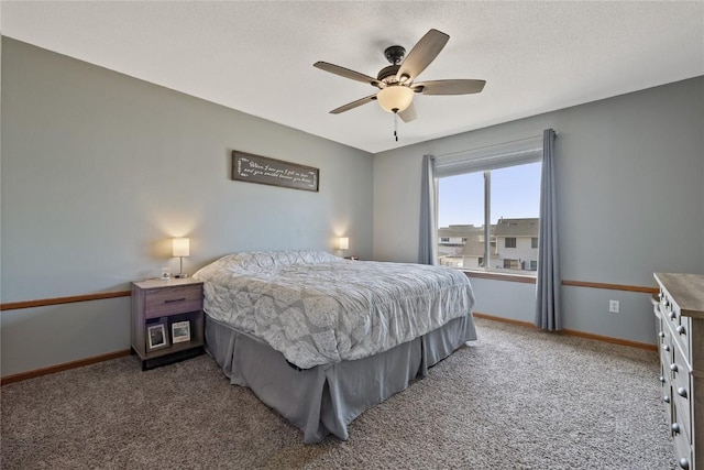 carpeted bedroom with ceiling fan and a textured ceiling