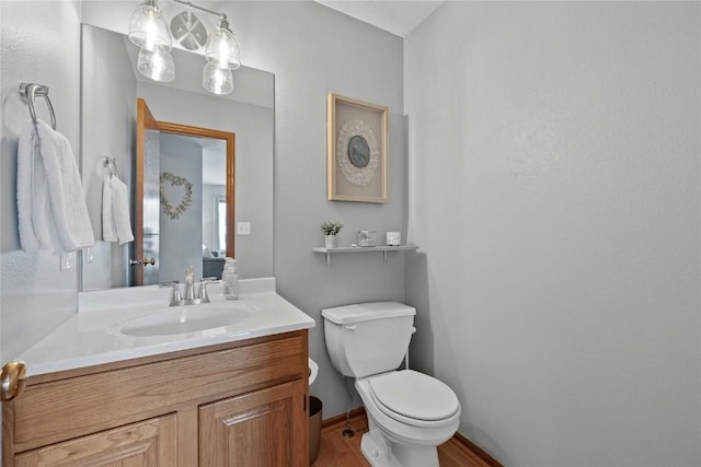 bathroom featuring vanity and toilet