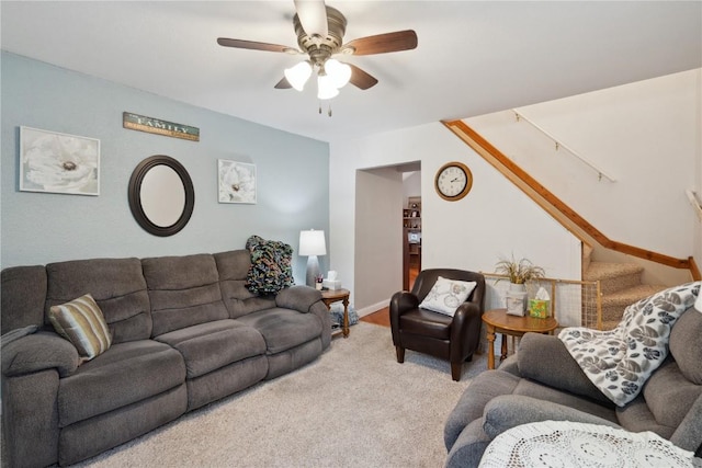 carpeted living room with ceiling fan