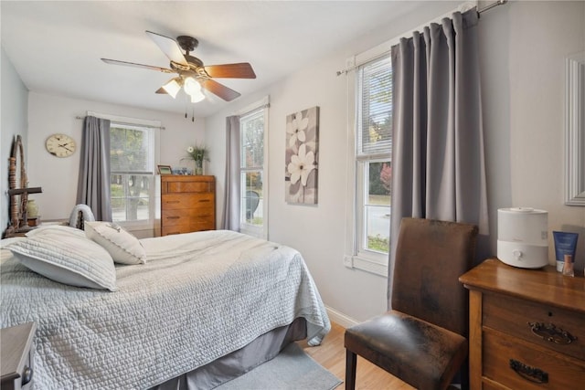 bedroom with ceiling fan and light wood-type flooring