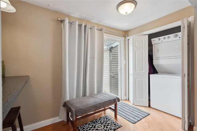 interior space featuring stacked washer and dryer and light wood-type flooring