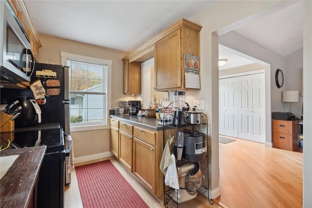 kitchen featuring electric range and light wood-type flooring