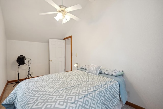 carpeted bedroom with ceiling fan and vaulted ceiling