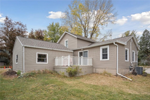 back of house with a wooden deck, a yard, and cooling unit