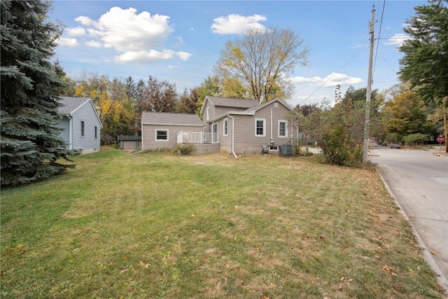 view of front of home featuring central AC unit and a front lawn