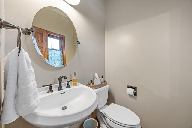 bathroom featuring sink and toilet