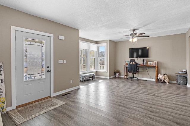 foyer with ceiling fan, hardwood / wood-style floors, and a textured ceiling