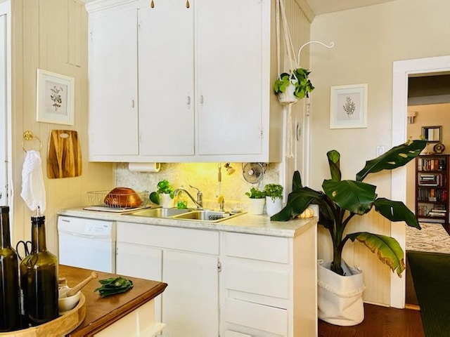 kitchen with white cabinetry, sink, and white dishwasher