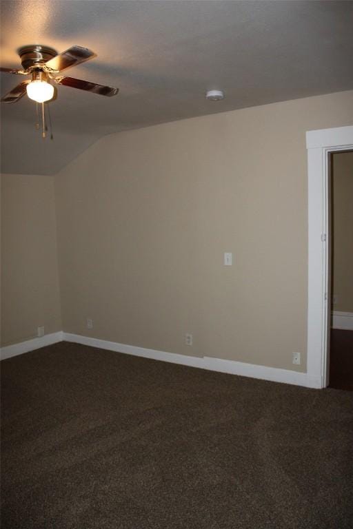 carpeted empty room with vaulted ceiling and ceiling fan