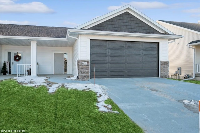 ranch-style house with a porch, a garage, and a front yard