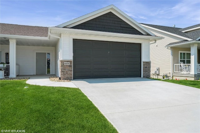 6431 Rookwood Ln, Marion, IA 52302 - view of front of house featuring driveway, a front lawn, an attached garage, a shingled roof, and stone siding