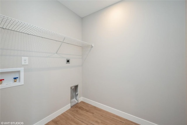 laundry area with washer hookup, wood-type flooring, and electric dryer hookup