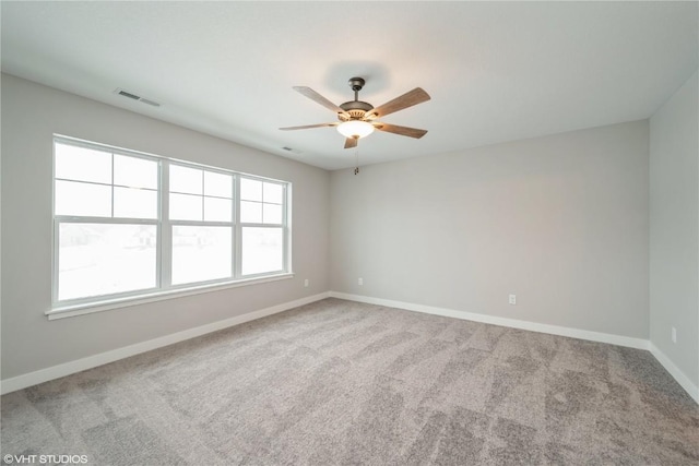 empty room with ceiling fan and carpet floors