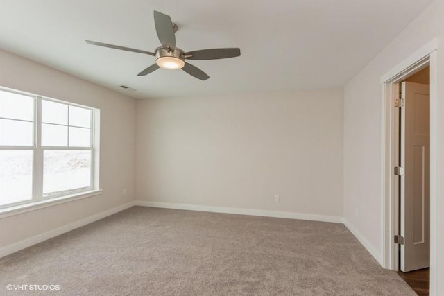 unfurnished room featuring ceiling fan and carpet flooring