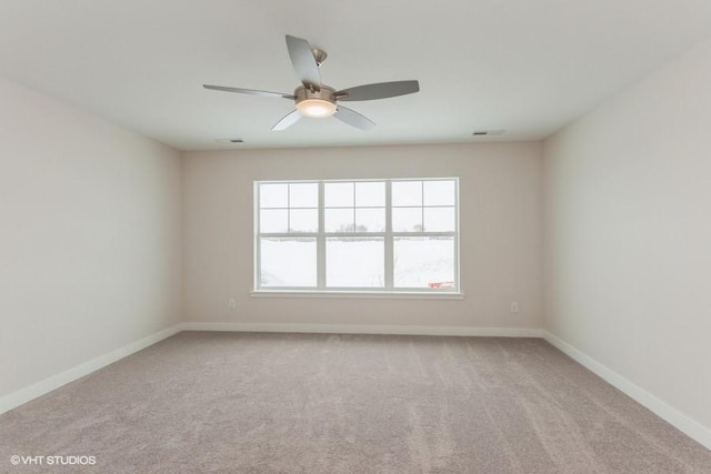 carpeted empty room featuring ceiling fan