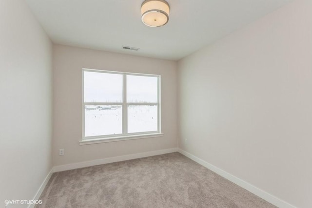 unfurnished room with light colored carpet