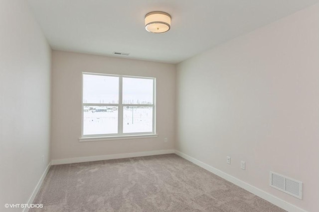 empty room with light colored carpet