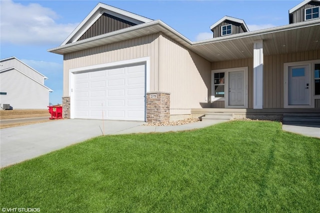 view of front of home with a garage, covered porch, and a front yard