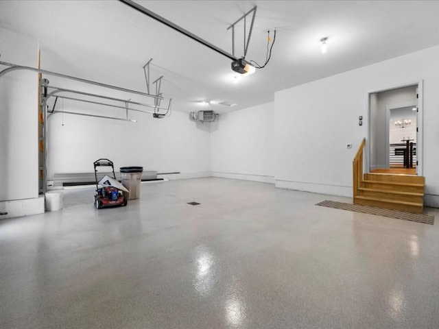 garage with an AC wall unit and a garage door opener