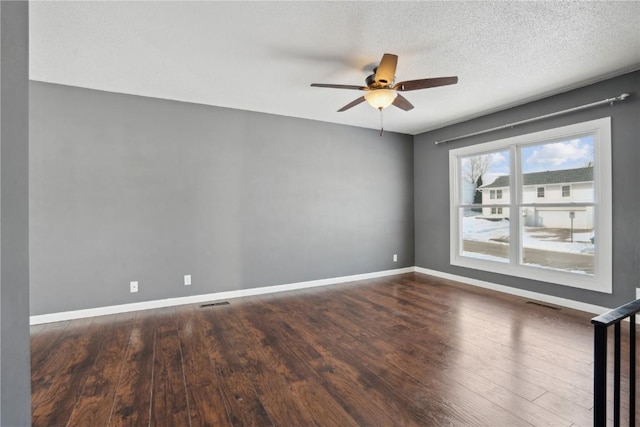 unfurnished room with a textured ceiling, dark hardwood / wood-style floors, and ceiling fan