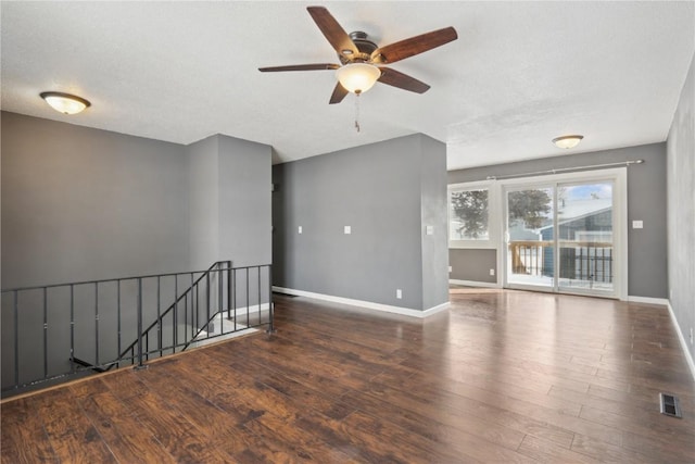 spare room featuring dark hardwood / wood-style floors and a textured ceiling