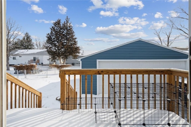 snow covered deck with a garage