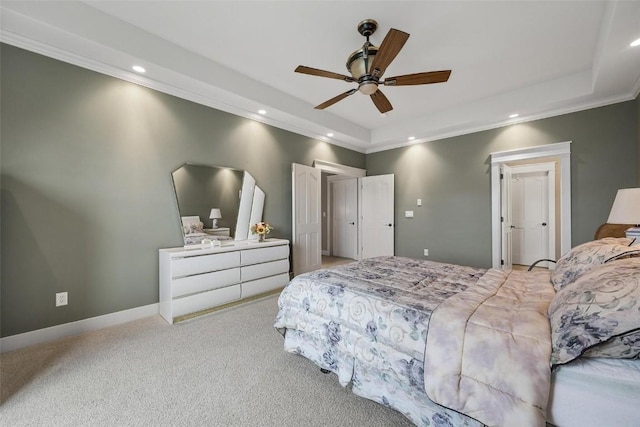 bedroom with ornamental molding, light carpet, ceiling fan, and a raised ceiling