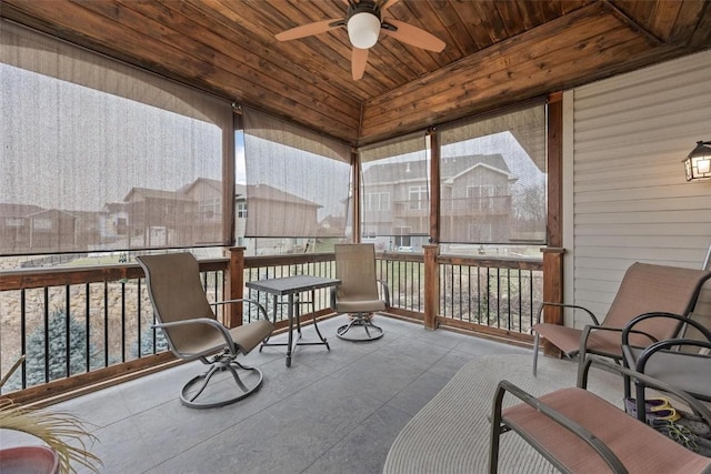 sunroom with ceiling fan and wood ceiling