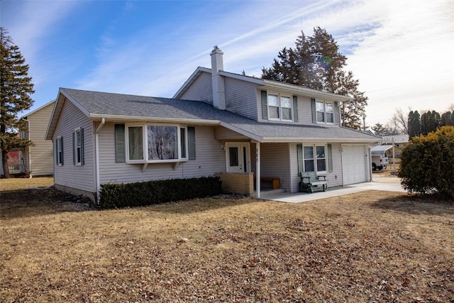 rear view of house featuring a garage and a lawn