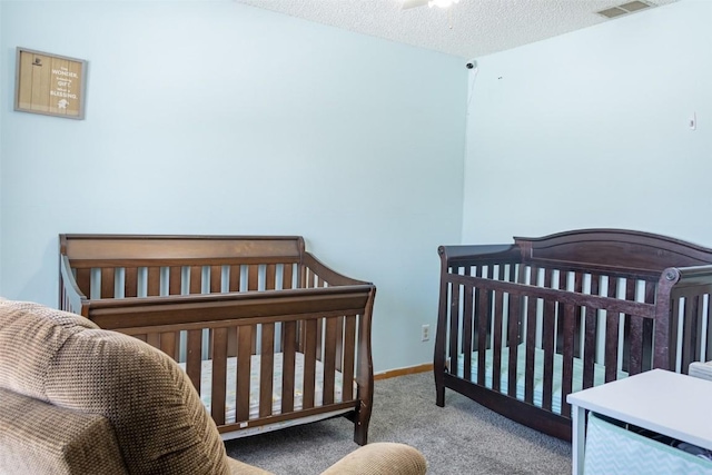 bedroom with carpet flooring and a textured ceiling