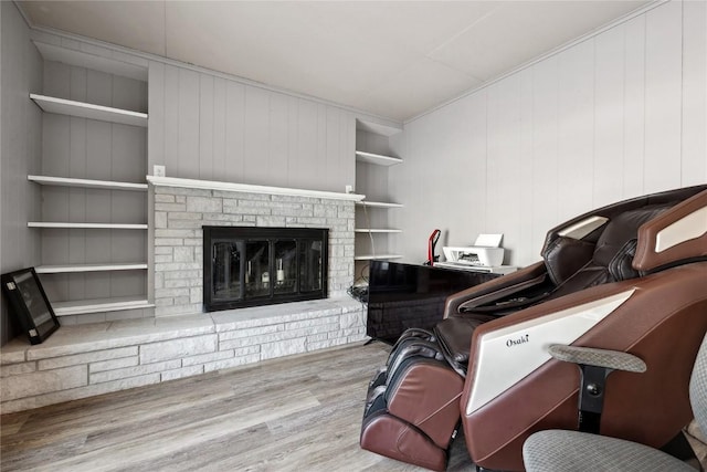 living room with light wood-type flooring and built in shelves