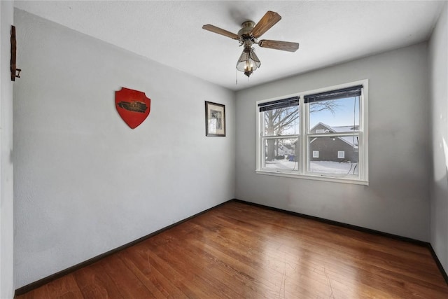 unfurnished room featuring ceiling fan and hardwood / wood-style floors