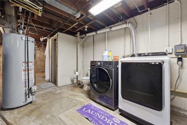 clothes washing area with gas water heater and separate washer and dryer