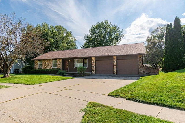 ranch-style house featuring a garage and a front lawn