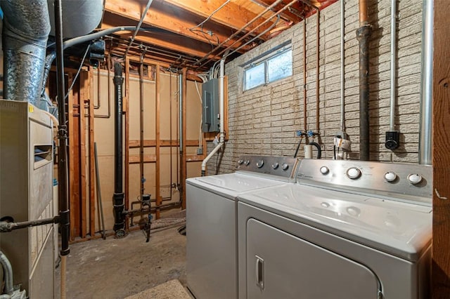 laundry area featuring electric panel and washer and clothes dryer