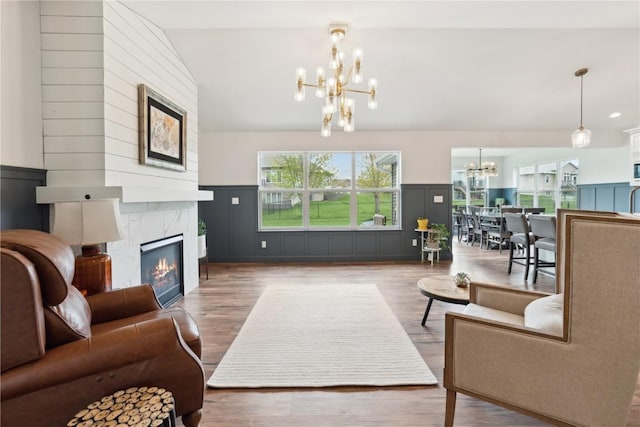 living area featuring a chandelier, a wainscoted wall, and a decorative wall