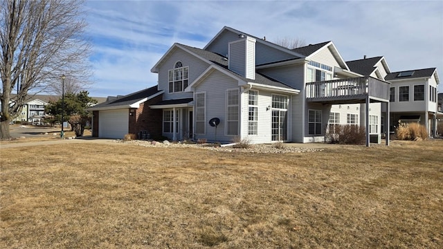 traditional-style home with a garage and a front lawn