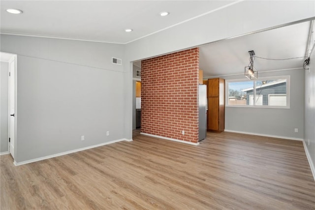 unfurnished living room featuring recessed lighting, baseboards, vaulted ceiling, light wood-style floors, and crown molding