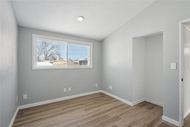 unfurnished room with light wood-style flooring and baseboards