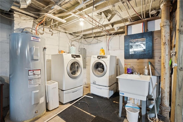 laundry room featuring a sink, laundry area, washing machine and clothes dryer, and electric water heater